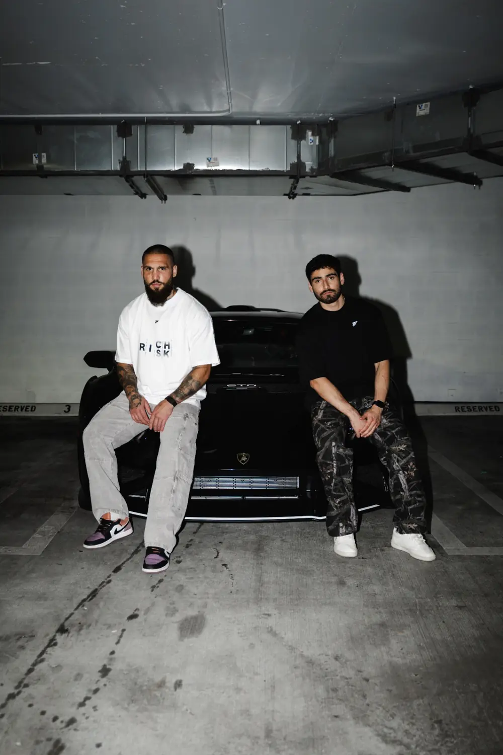 Group wearing Trader Fits tees and hoodies on location
